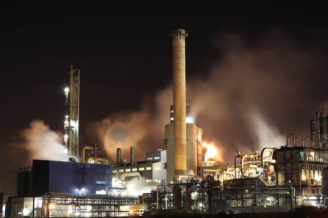 Free Brown and White Factory Building during Night Time Stock Photo